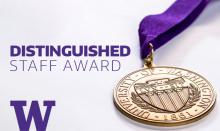 A bronze medal with the words University of Washington 1861 engraved on it and a purple ribbon attached to it sits atop a white background with the capital letter W in the lower left-hand corner and the words Distinguished Staff Award off to the left
